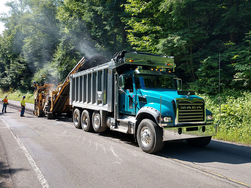 Jefferson Paving milling equipment and truck on a roadway